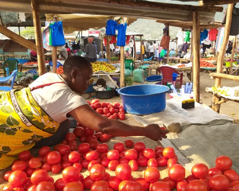 Tomatoes being sold in piles of four